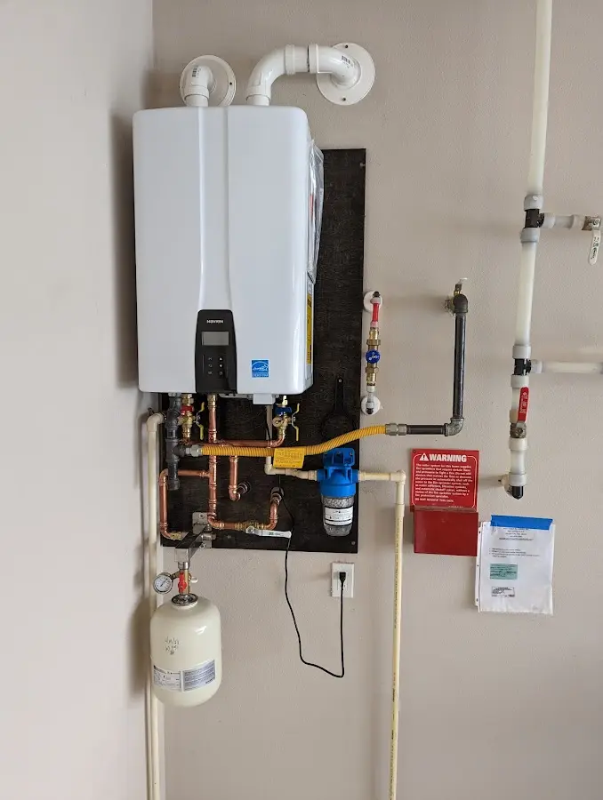 Professional plumber installing copper piping in a Hyrum home